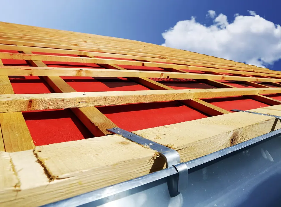 Timber battens over red membrane on a roof